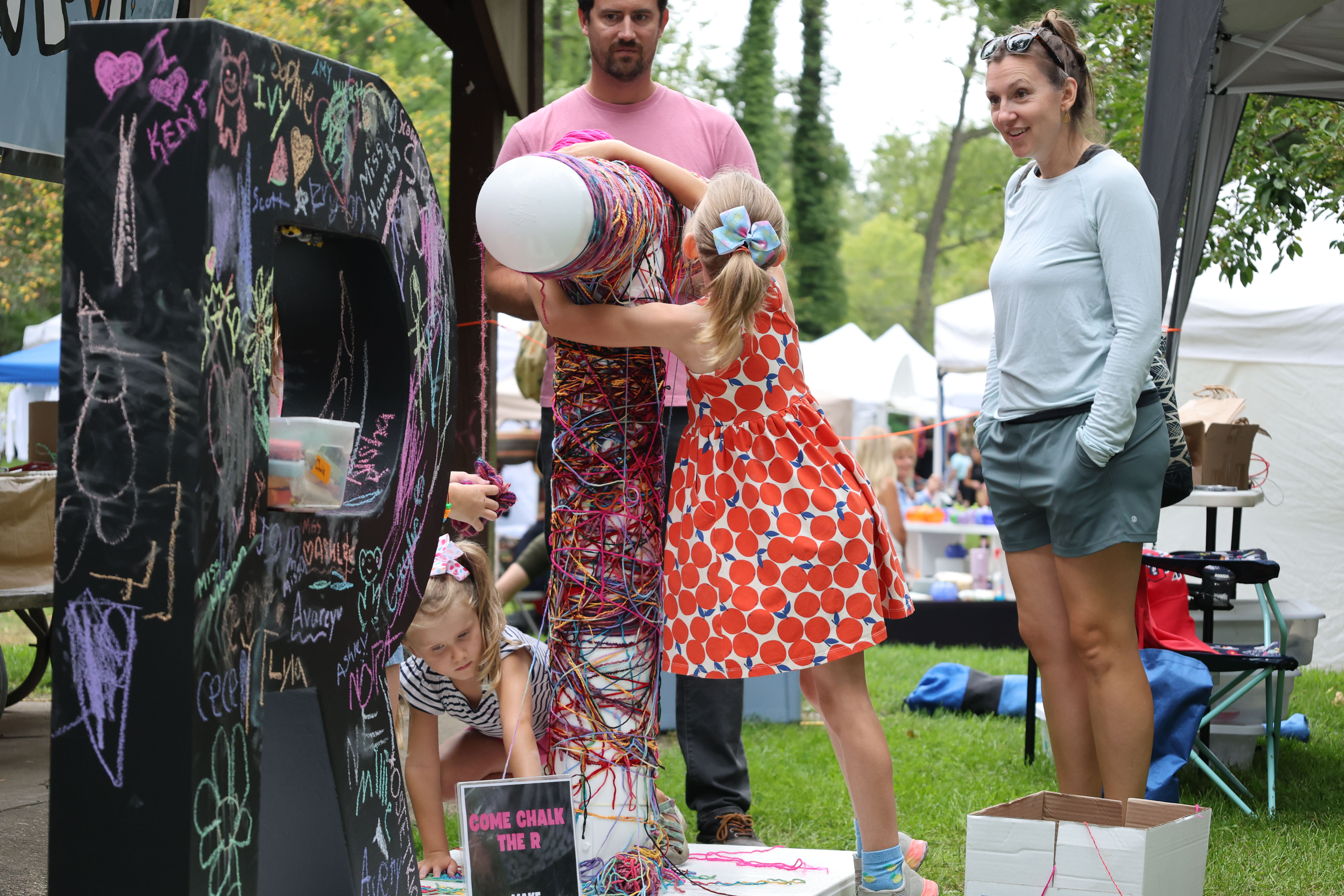 Kid hugging "ART" sign