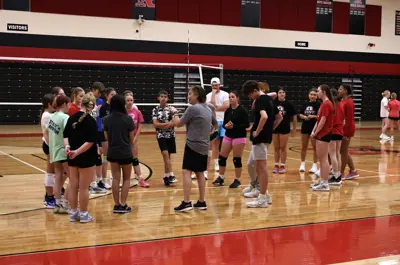 coach talking to volleyball players