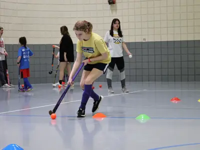 Girl doing field hockey drills 